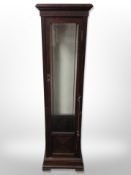 A glazed oak slender cabinet,