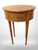 An early 20th century satinwood oval occasional table fitted a drawer,