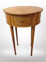 An early 20th century satinwood oval occasional table fitted a drawer,