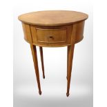 An early 20th century satinwood oval occasional table fitted a drawer,