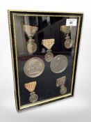 A framed montage of medals including 'The St.
