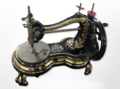 A Victorian gilded cast iron sewing machine, retailed by Fattorini & Sons, Bradford,