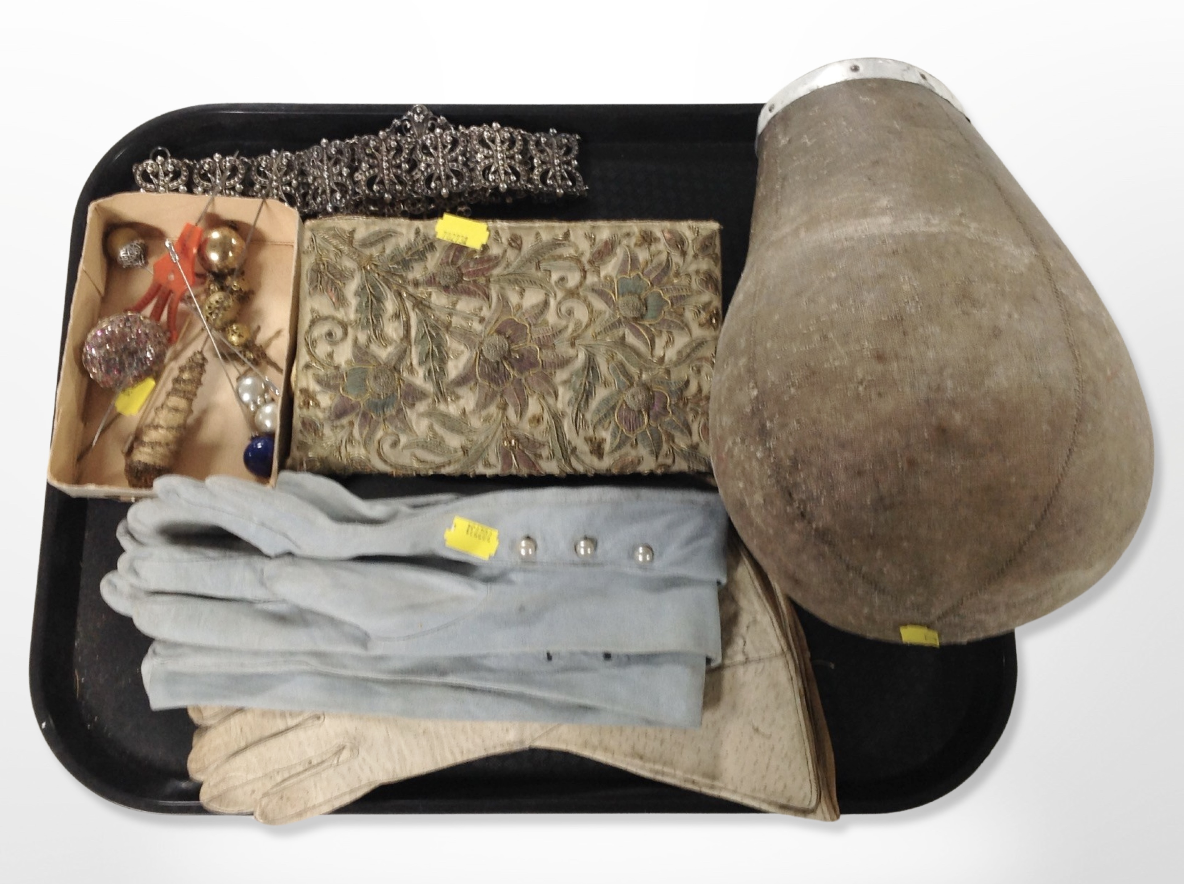 A 20th century milliner's canvas hat block together with two pairs of antique calf skin gloves,