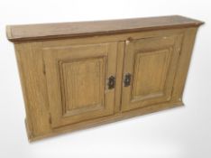 A 19th century scumbled pine double door cabinet,