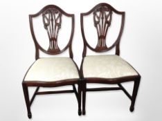 A pair of reproduction shield backed mahogany dining chairs