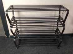 A contemporary wrought metal shoe rack,