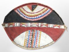 A decorative painted hide shield,