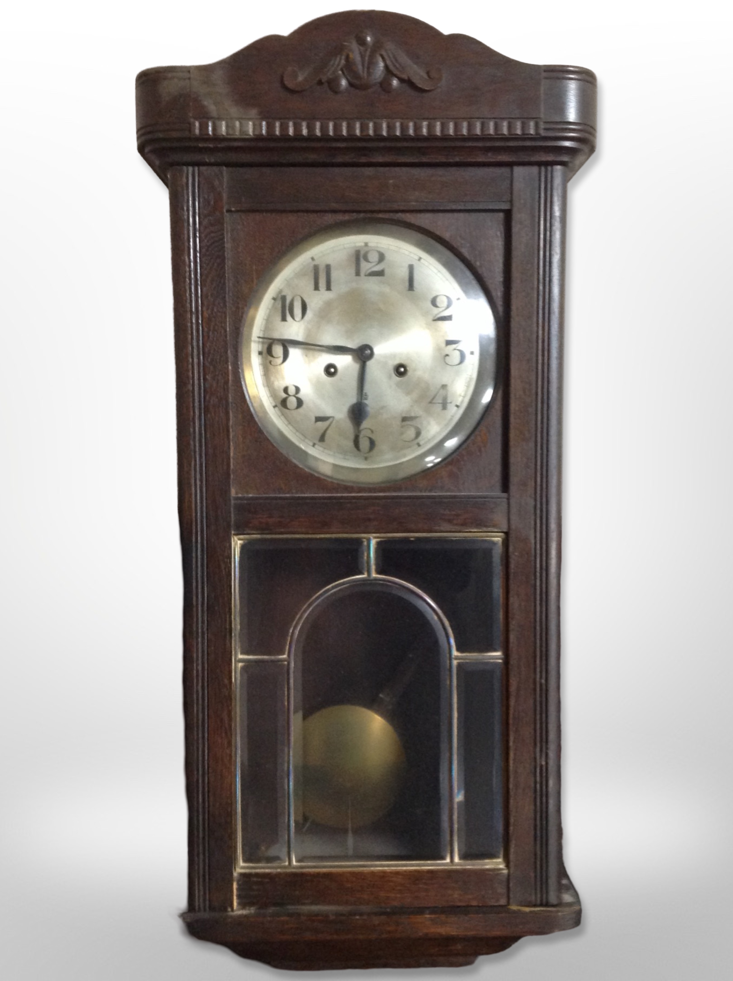 An early 20th century Continental oak eight day wall clock,