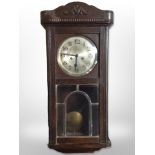 An early 20th century Continental oak eight day wall clock,