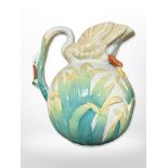 An early 20th century English pottery jug, the handle and spout in the form of a swan,