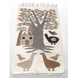 A pictorial Kilim rug depicting stylized birds beneath a tree,