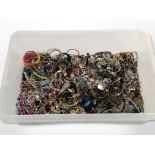 A large plastic crate of mixed costume jewellery