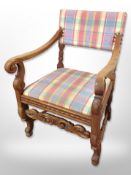 A 20th century Danish carved oak scroll arm chair in checkered fabric,