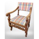 A 20th century Danish carved oak scroll arm chair in checkered fabric,