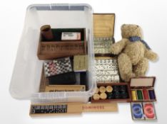 A teddy bear and a quantity of dominoes, draughts set, other games,