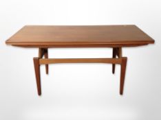 A 20th century teak pull out extending dining table,