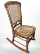 A beech and cane rocking chair