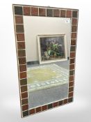 A Danish mirror with tiled surround,