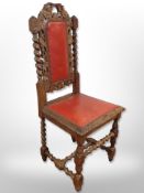 A heavily carved oak barley twist chair