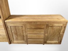 A contemporary Barker & Stonehouse hardwood sideboard fitted with cupboards and drawers,