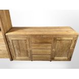 A contemporary Barker & Stonehouse hardwood sideboard fitted with cupboards and drawers,