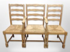 A set of six rush seated ladder backed kitchen chairs
