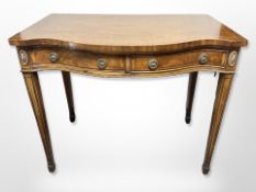 A reproduction inlaid mahogany serpentine fronted side table fitted with two drawers,