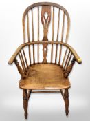 A 19th century elm spindle backed armchair,