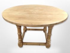 A pine circular dining table,
