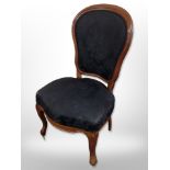 A Continental walnut salon chair in black floral upholstery