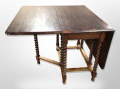 An Edwardian oak barley twist dining table, 147 cm long x 100 cm wide x 76 cm high (extended),