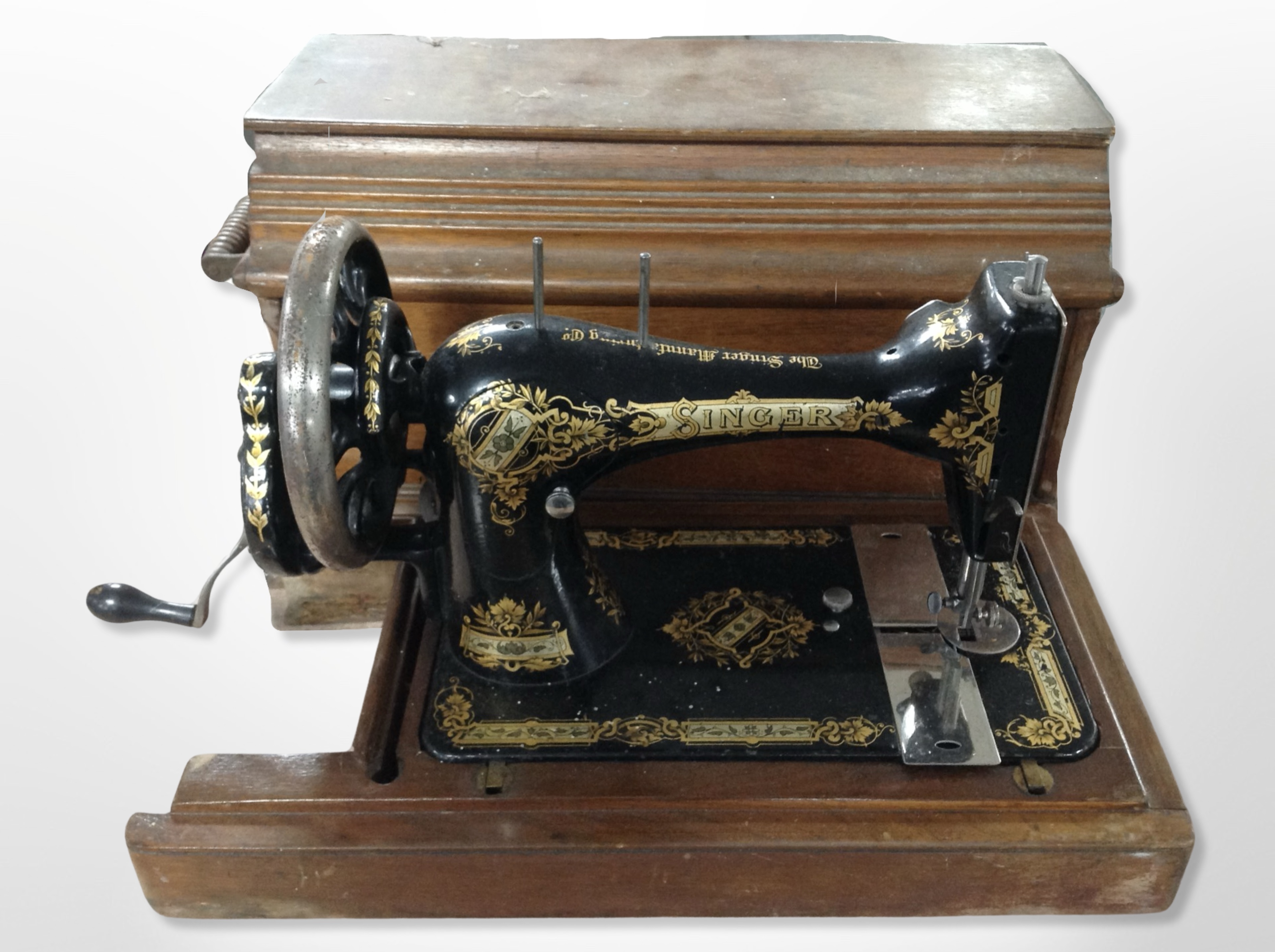 Two antique Singer hand sewing machines in boxes