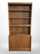 A G-Plan teak open bookcase, width sliding door cabinet beneath,
