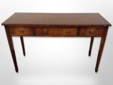 A reproduction mahogany three drawer side table,