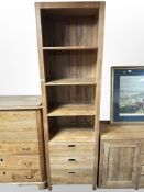 A contemporary Barker & Stonehouse hardwood bookcase fitted with three drawers,