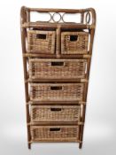 A wicker stand fitted with six drawers,