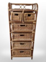 A wicker stand fitted with six drawers,