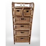 A wicker stand fitted with six drawers,