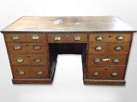 A Victorian pine twin pedestal desk fitted nine drawers,