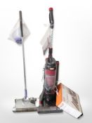A Vax upright cleaner and a G Tech electronic cordless sweeper