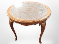 A circular beech and rattan glass topped occasional table on pad feet,