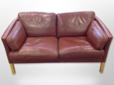 A late 20th century Danish Stouby Burgundy leather two seater settee,