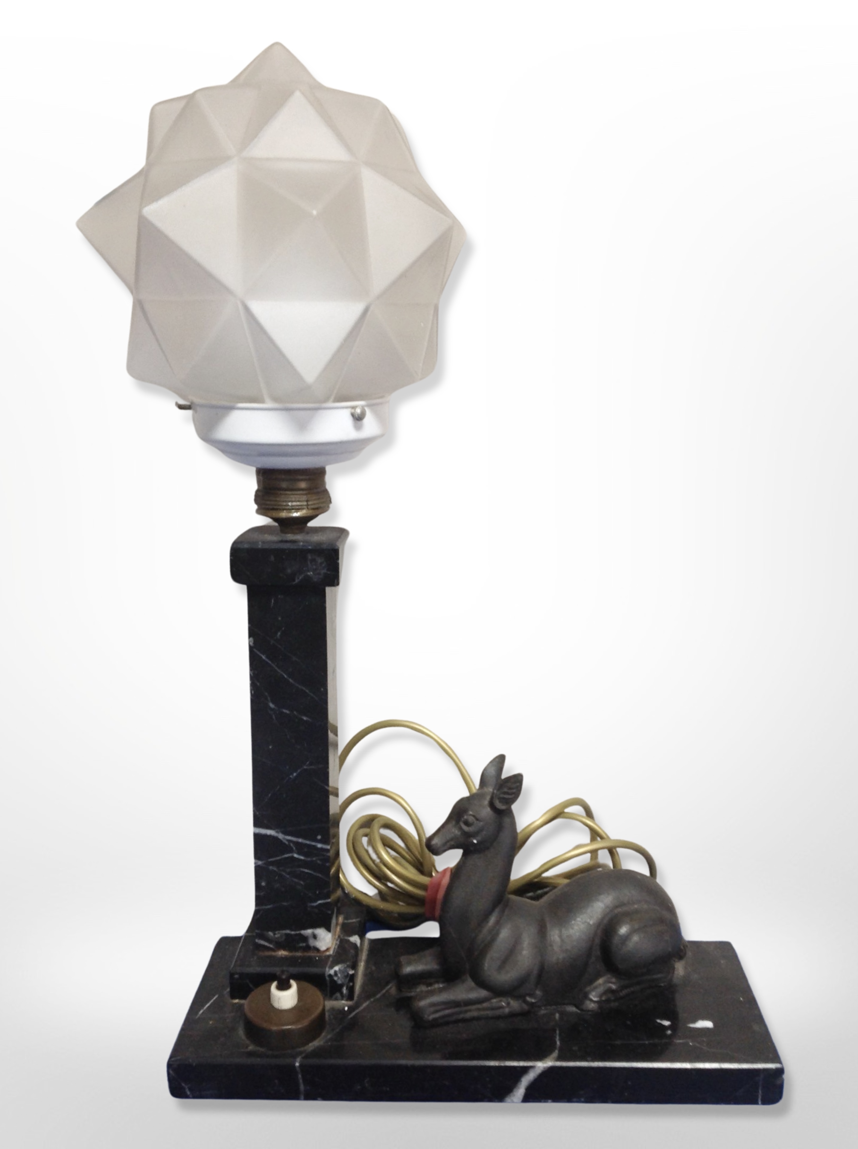 An Art Deco marble and frosted glass table lamp surmounted by a recumbent deer,