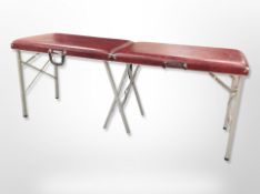 An aluminium and red vinyl foldng massage table