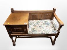An oak linen fold telephone seat,