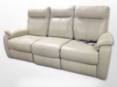 A beige stitched leather three seater electric reclining settee,