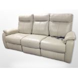 A beige stitched leather three seater electric reclining settee,