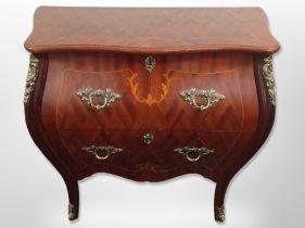 A reproduction French-style bombé commode two drawer chest,