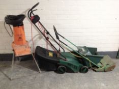 An Alko electric garden shredder and a Qualcast mower,