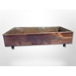 A 19th century copper plant pot tray on raised legs,